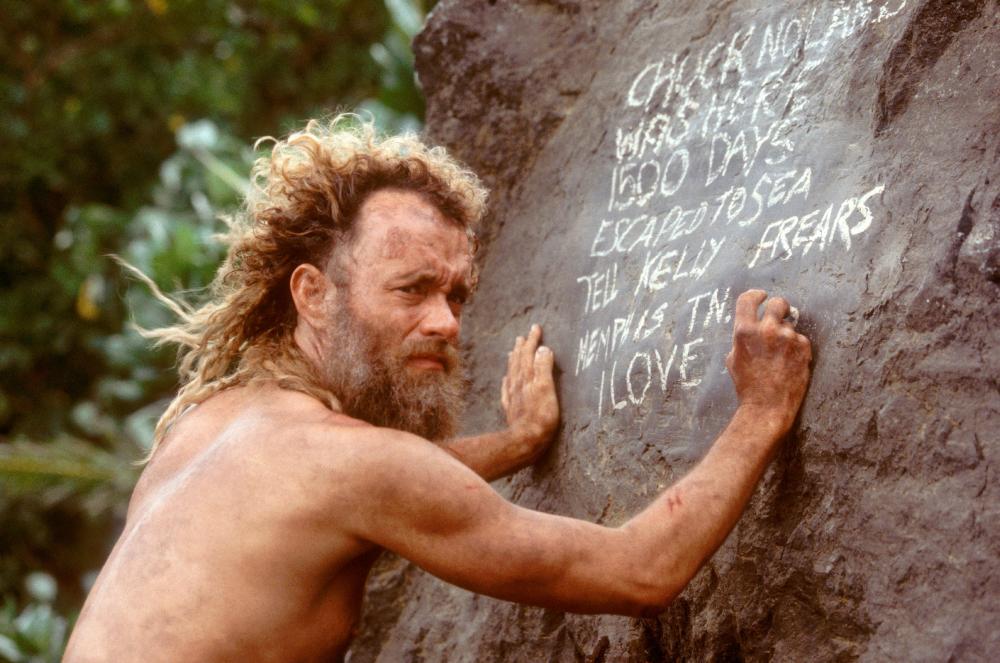 CAST AWAY, Tom Hanks writing a message on a rock, 2000. TM and Copyright (c) 20th Century Fox Film Corp. All rights reserved.